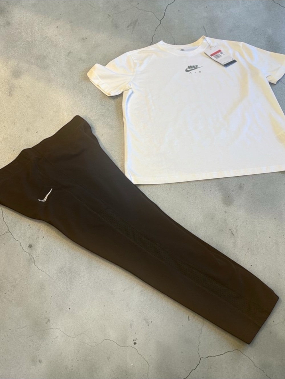 Nike Girls White Logo Tee with Black Jogger Bottoms. The shirt is NWT
